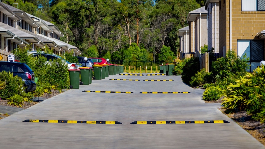 Driveway with black and yellow speed bumps
